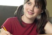 Teen girl writing in notebook